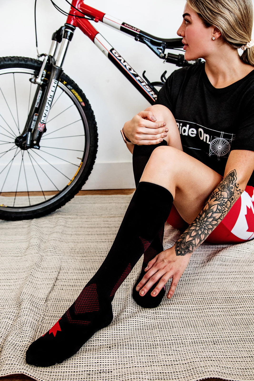 Biker seated in front of bicycle in Lunatik Strong 'N Free 1 compression socks.