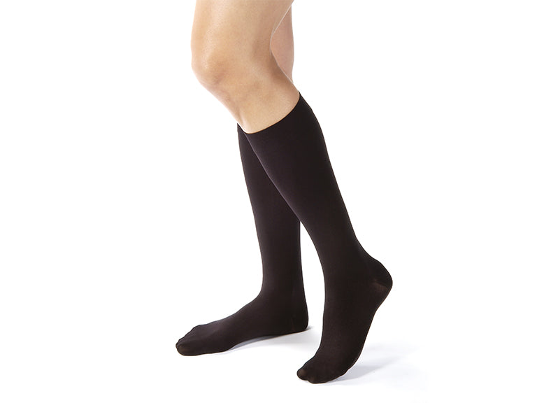 Lower legs of model in knee-high JOBST Opaque compression socks.