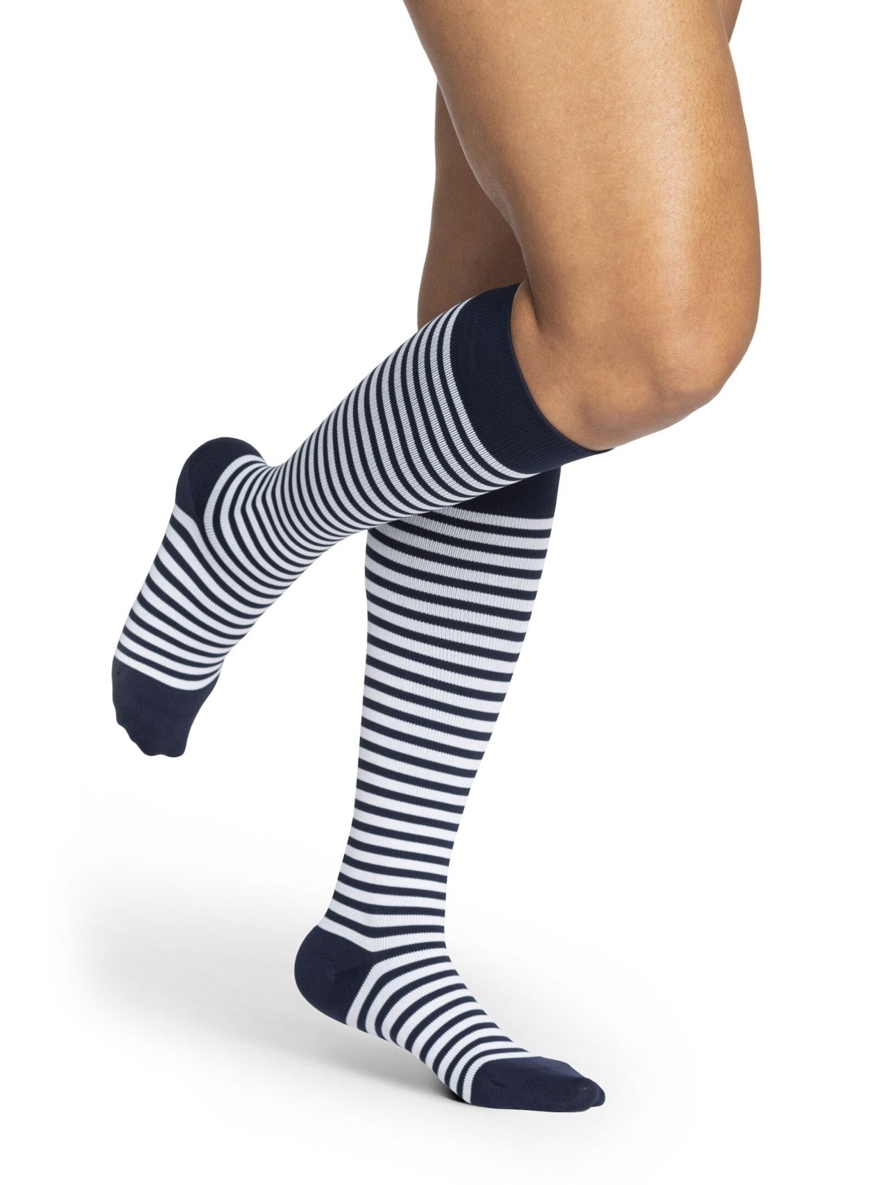 Legs of female model in Sigvaris Microfiber Patterns compression socks in mariner stripe.