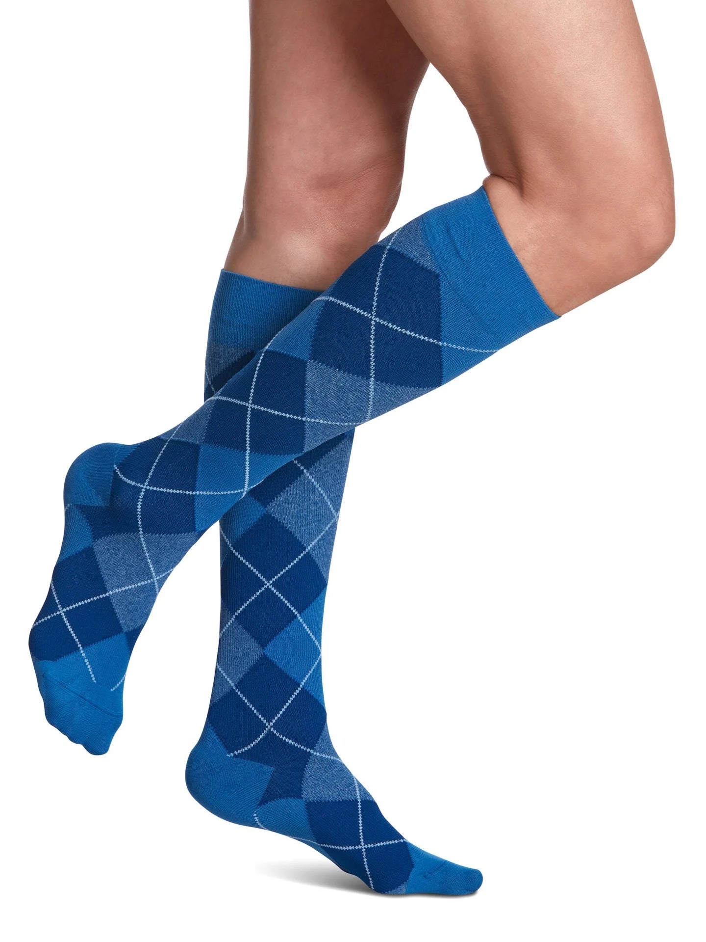 Legs of female model in Sigvaris Microfiber Patterns compression socks in royal blue argyle.