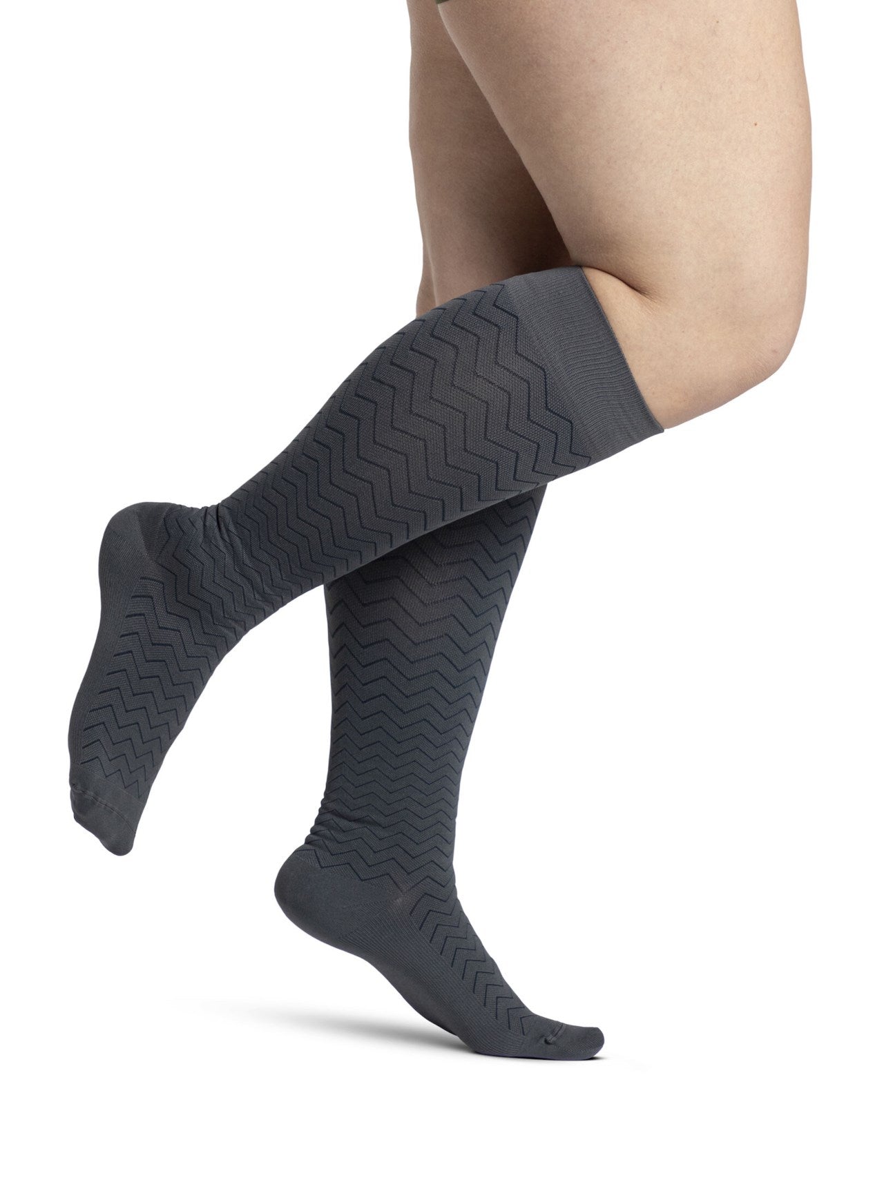 Legs of female model in Sigvaris Microfiber Patterns compression socks in graphite chevron.