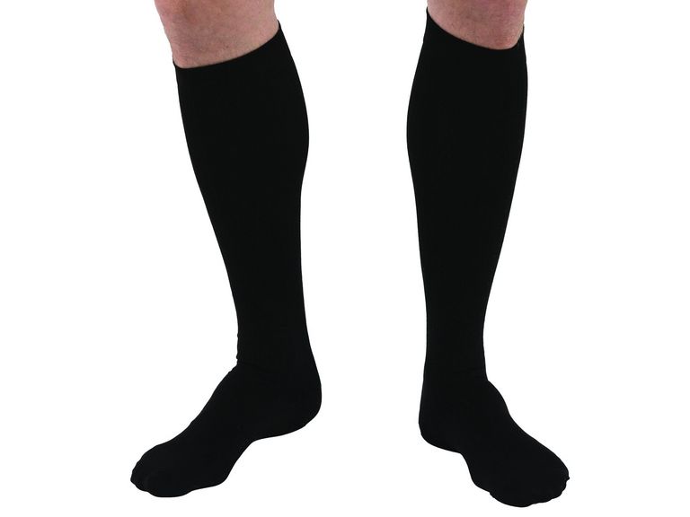 Lower legs of model in JOBST For Men compression socks in black.