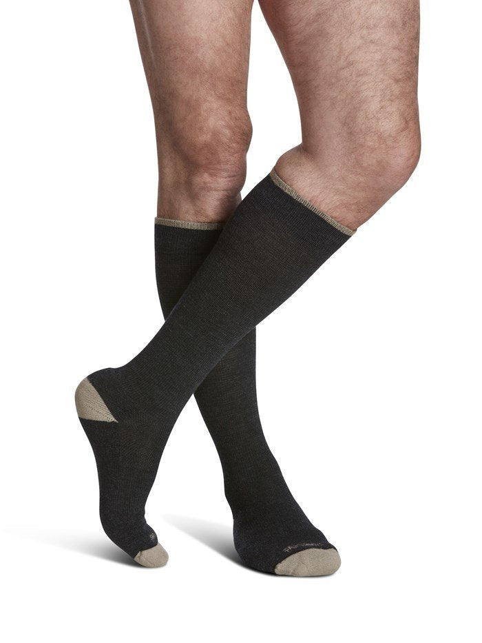 Legs of male model in Sigvaris Thermoregulating Wool compression socks in charcoal.