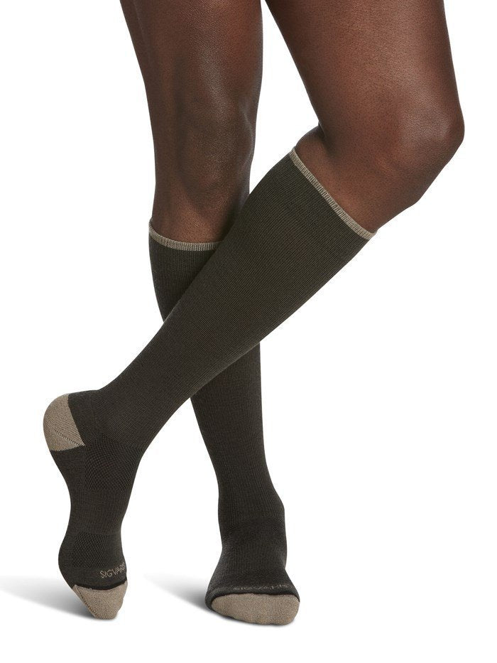 Legs of male model in Sigvaris Thermoregulating Wool compression socks in olive.