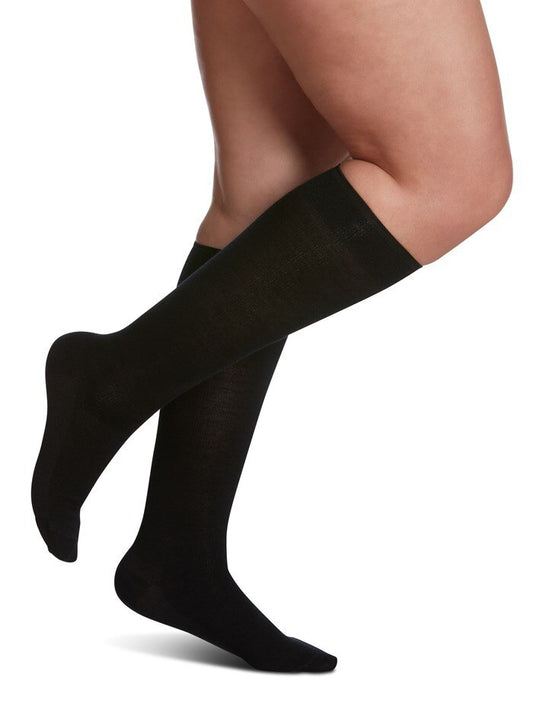 Legs of model in Sigvaris Merino Wool compression socks in black.