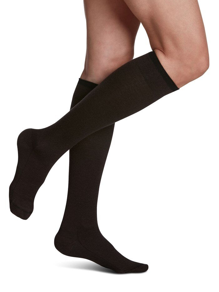 Legs of model in Sigvaris Merino Wool compression socks in brown.