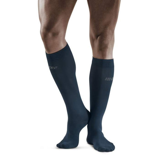 Lower legs of male model wearing knee-high CEP Business compression socks in blue.