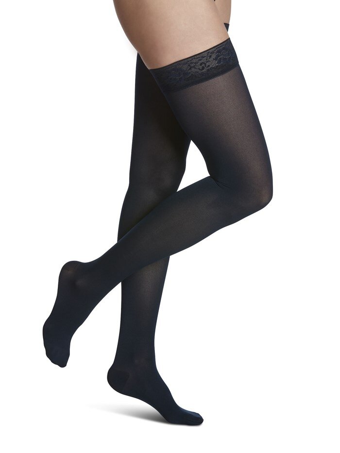 Legs of female model in Sigvaris Soft Opaque compression calf socks in black.