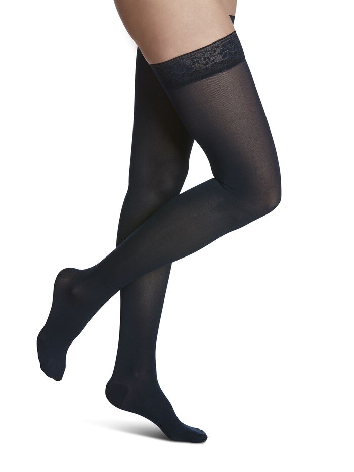 Legs of female model in Sigvaris Soft Opaque compression calf socks in midnight blue.