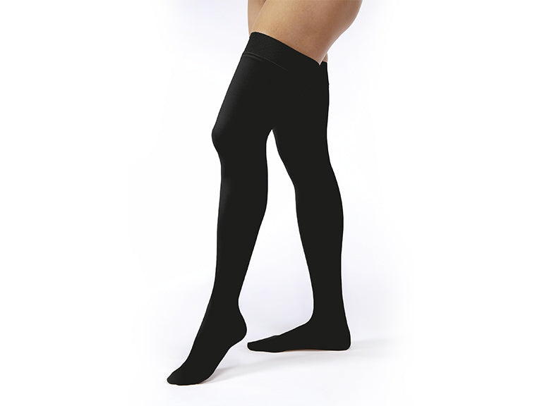 Legs of model in thigh-high JOBST Opaque compression tights in black.