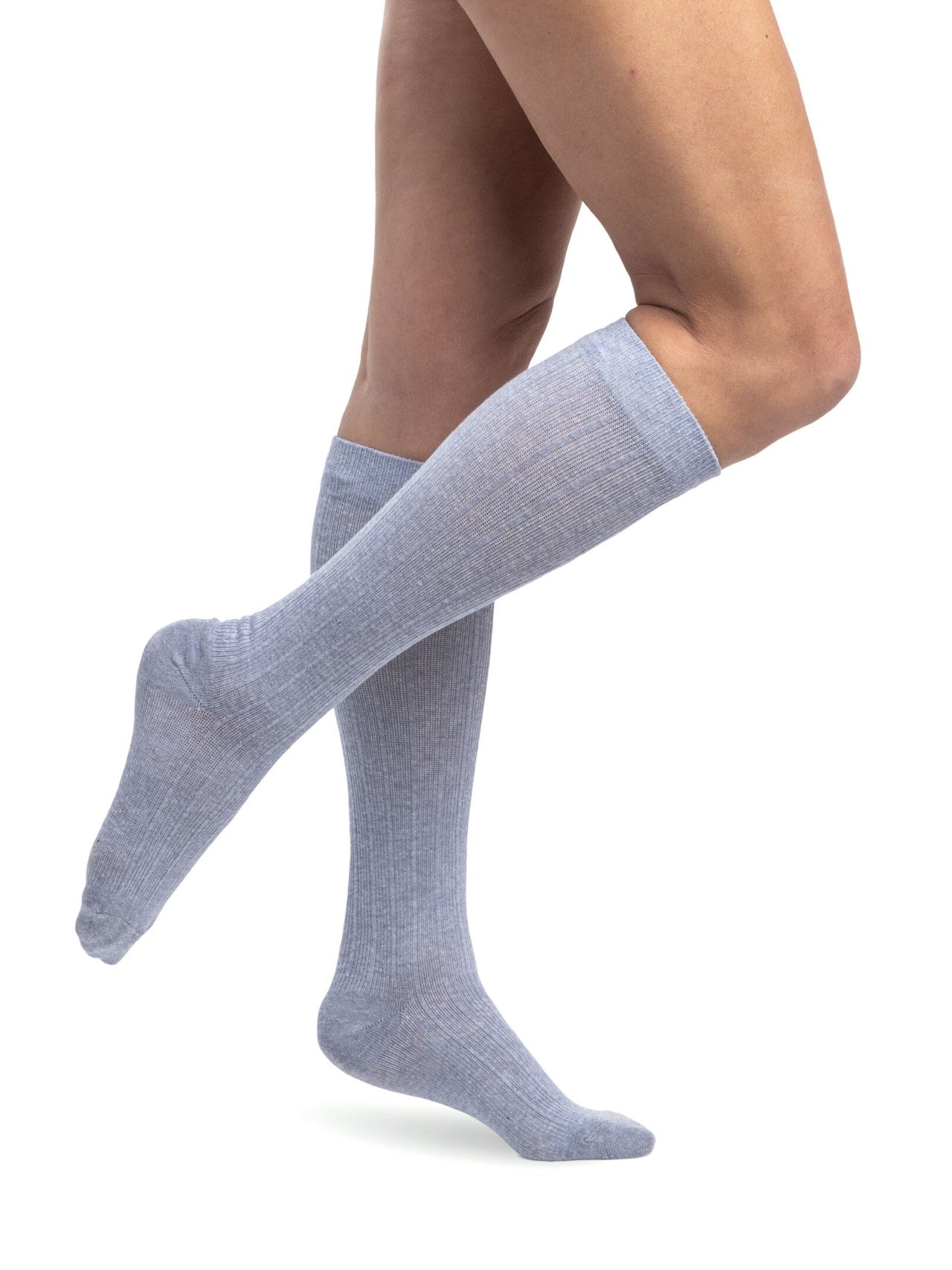 Legs of model in Sigvaris Linen compression calf socks in denim.