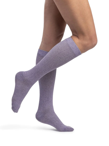 Legs of model in Sigvaris Linen compression calf socks in lavendar.