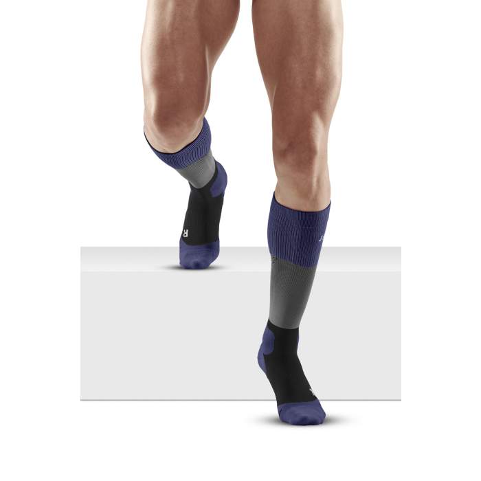 Lower legs of male model in knee-high CEP Max Cushion compression socks in grey/purple.