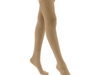 Legs of model in thigh-high JOBST UltraSheer compression tights in silky beige.