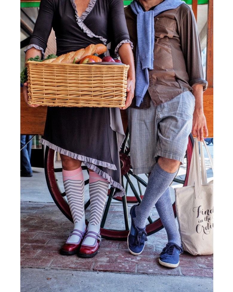 Lunatik Denim Cool compression socks on two women in comfortable clothing at a farmer's market, one holding a basket of produce.