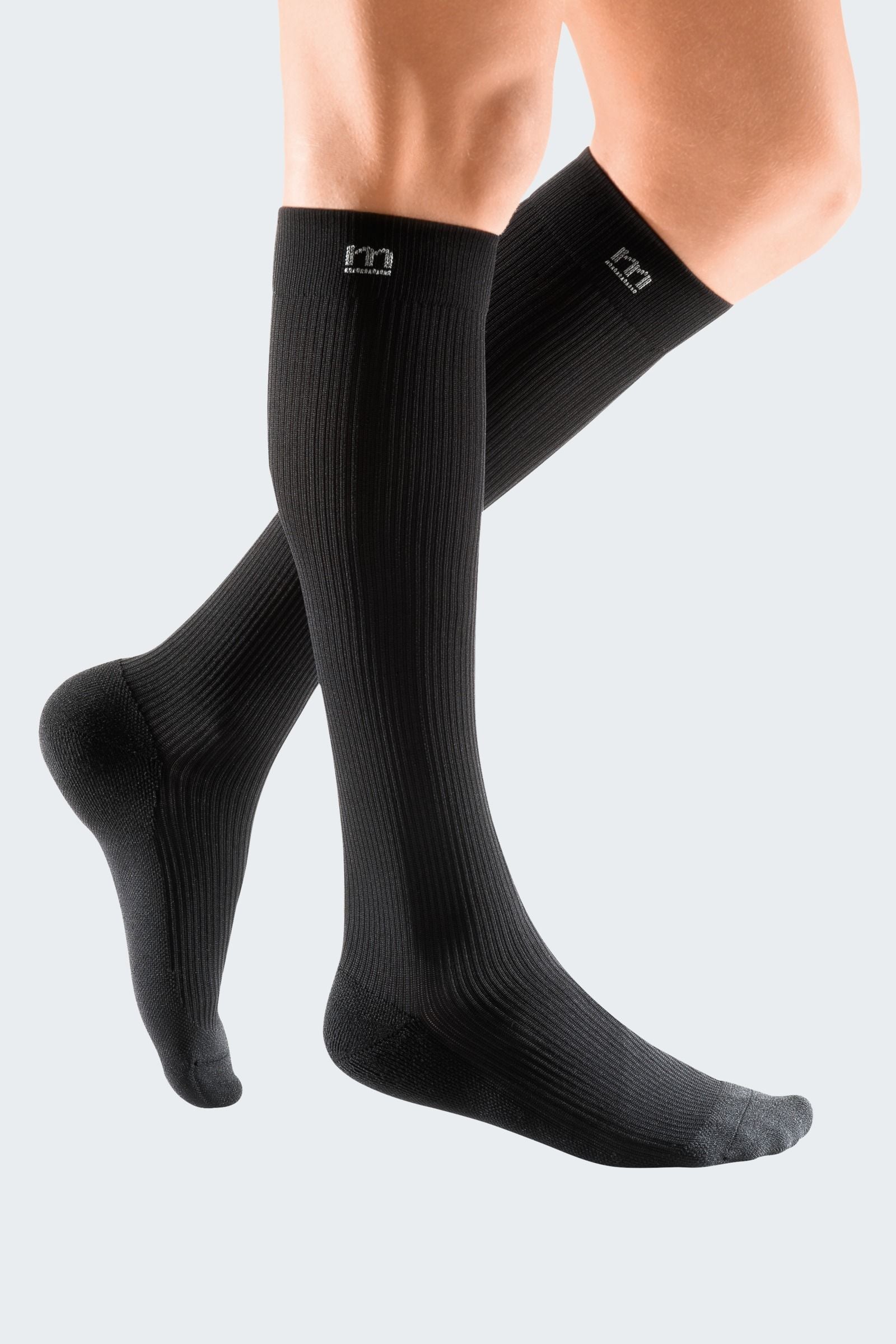 Lower legs of model in Mediven Active compression socks in black.