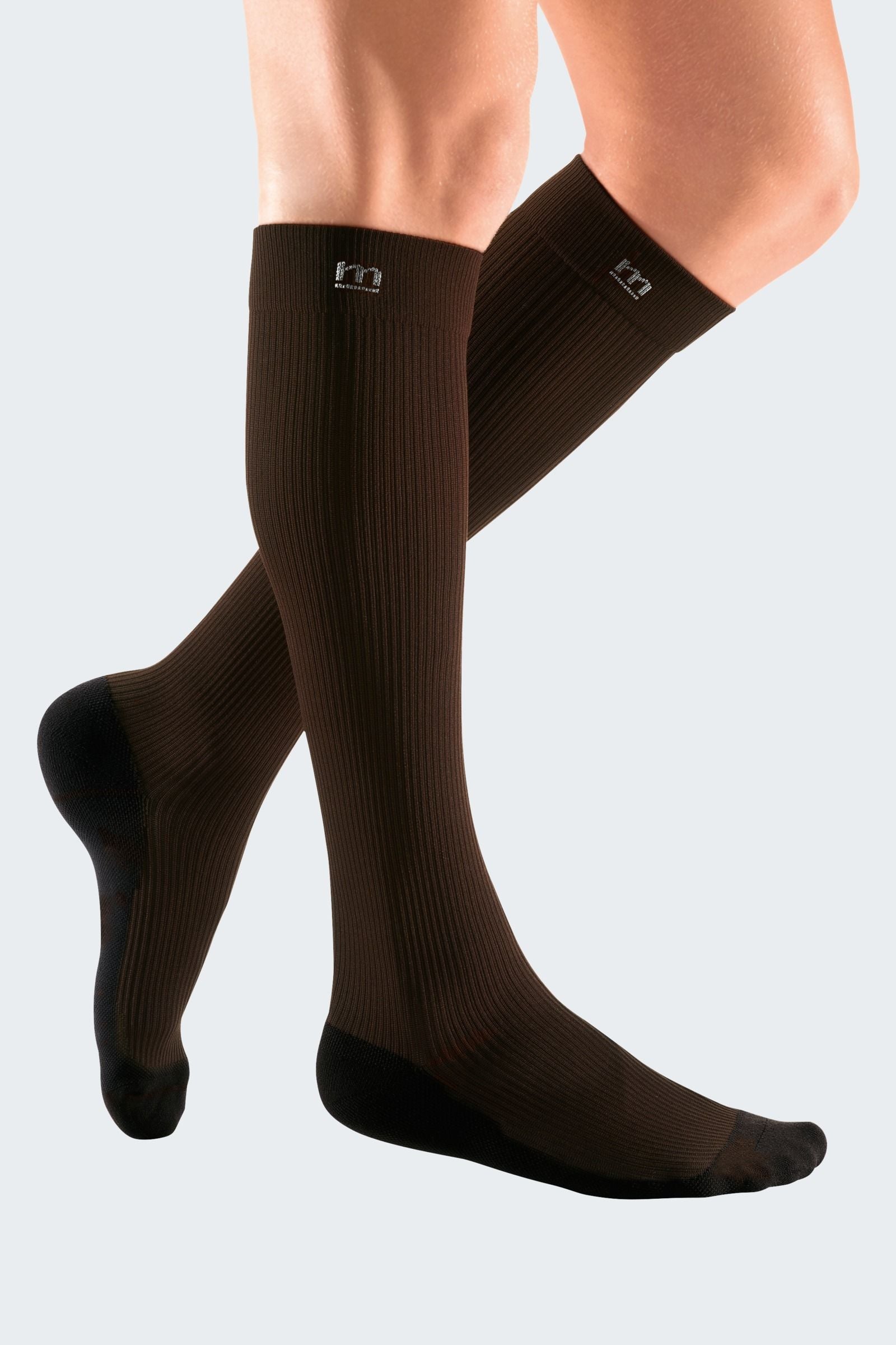 Lower legs of model in Mediven Active compression socks in brown.