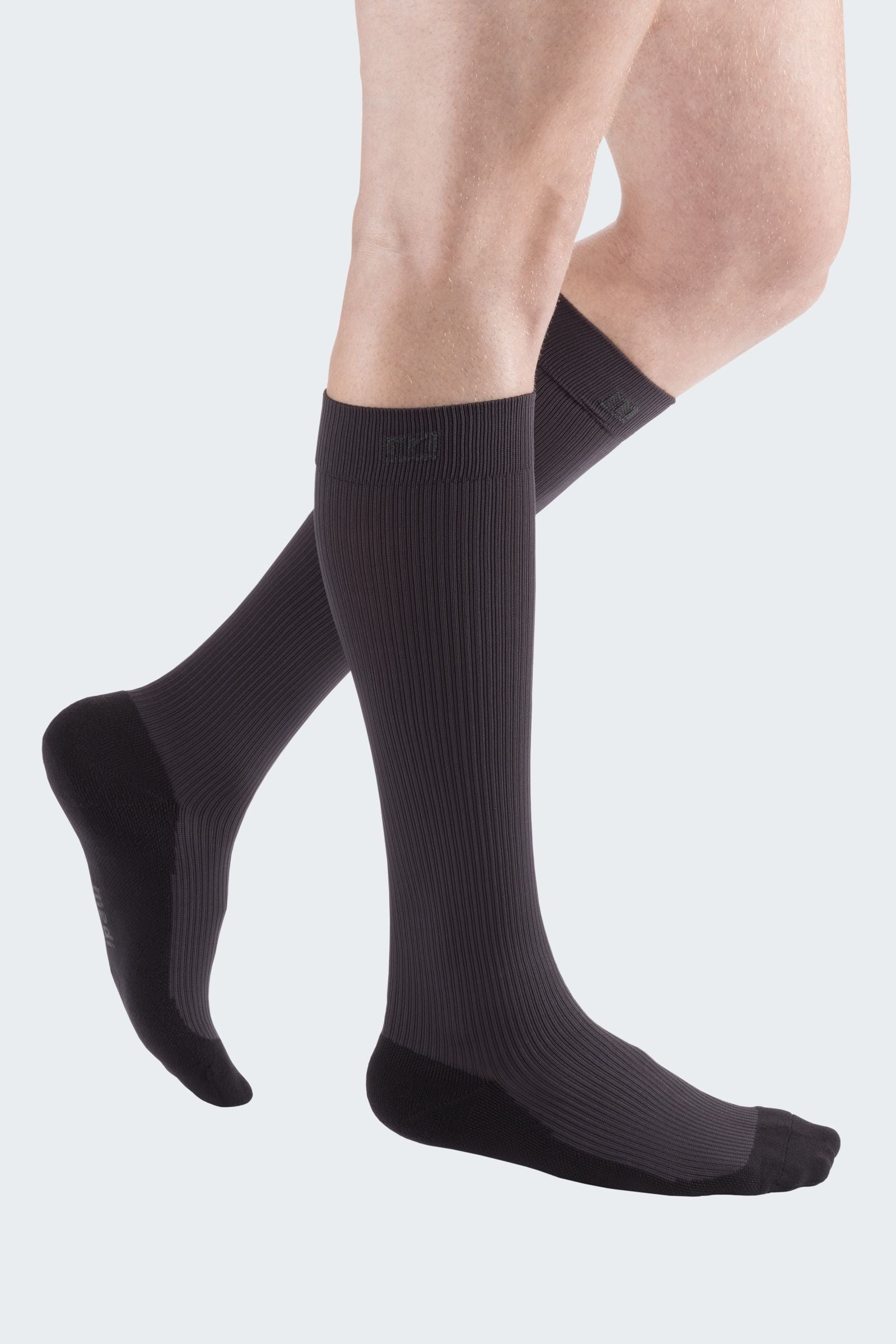 Lower legs of model in Mediven Active compression socks in anthracite.