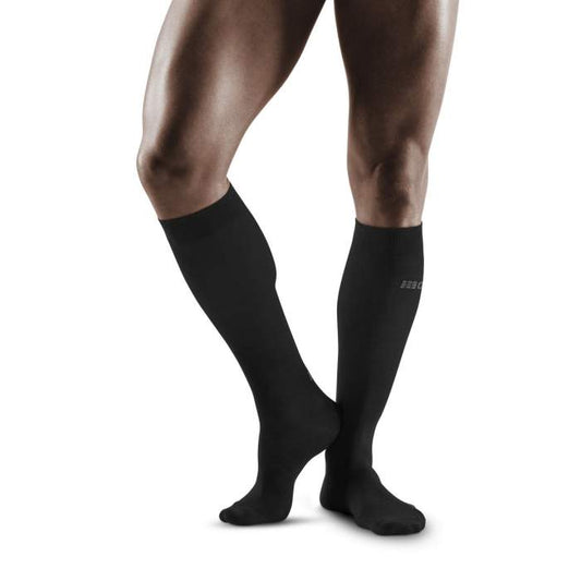 Lower legs of male model wearing knee-high CEP AllDay recovery compression socks in anthracite.
