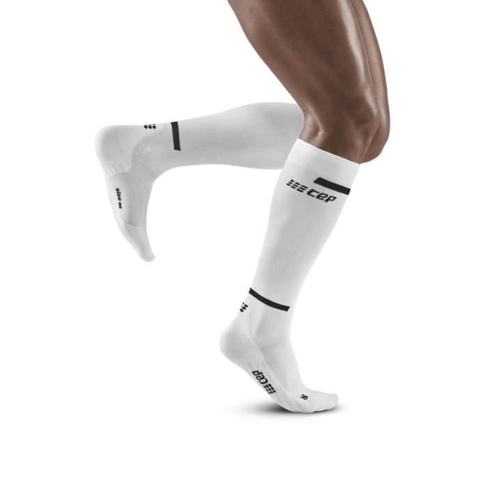 Lower legs of model in knee-high CEP The Run 4.0 compression tights in white.