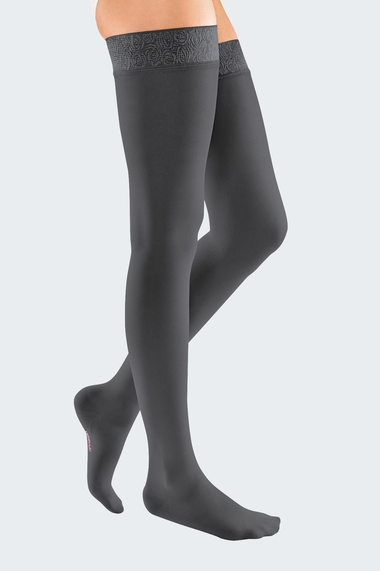 Lower body of female model in thigh-length Mediven Elegance compression tights in anthracite.
