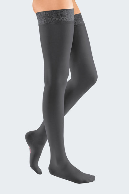 Lower body of female model in thigh-length Mediven Elegance compression tights in anthracite.