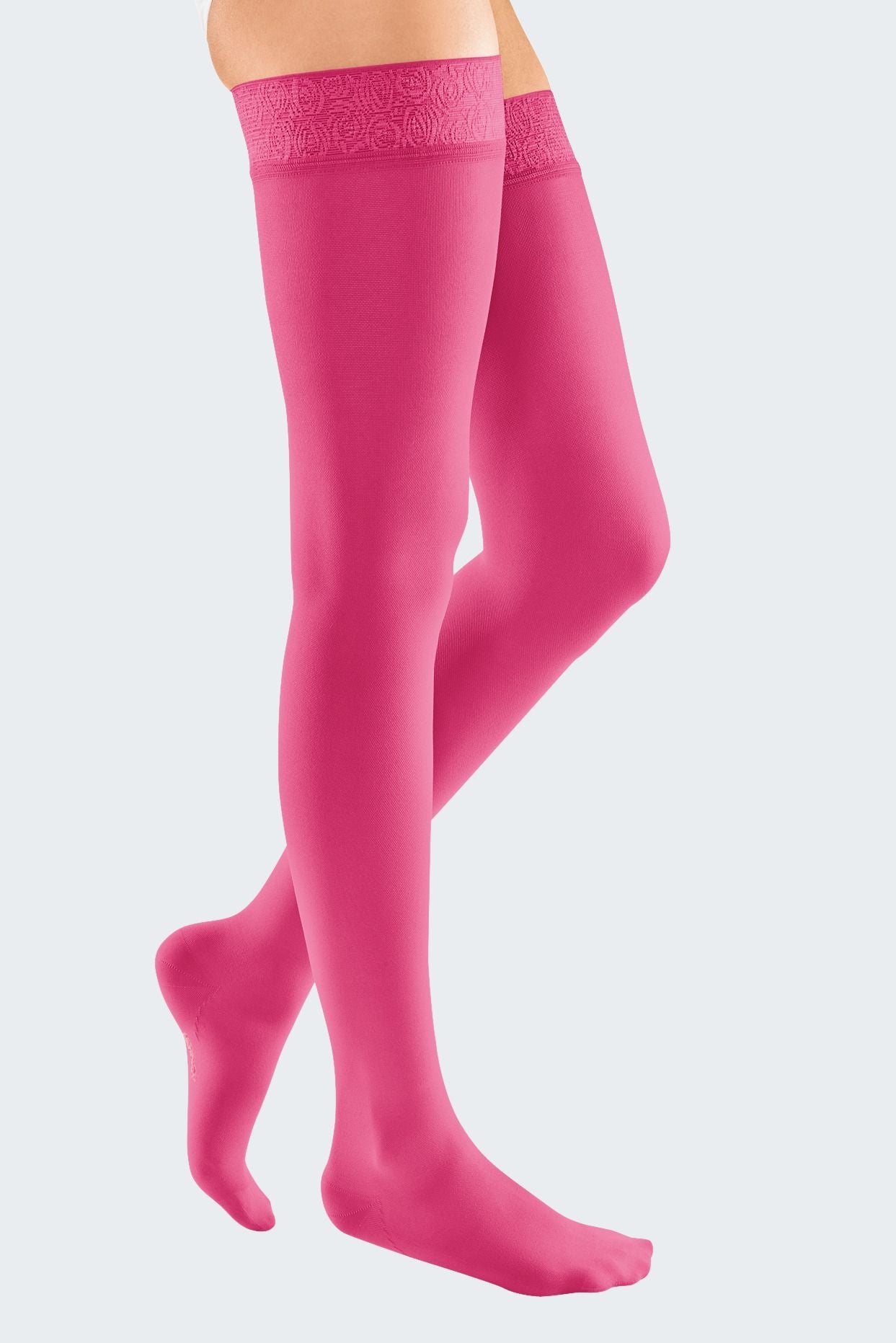 Lower body of female model in thigh-length Mediven Elegance compression tights in magenta.