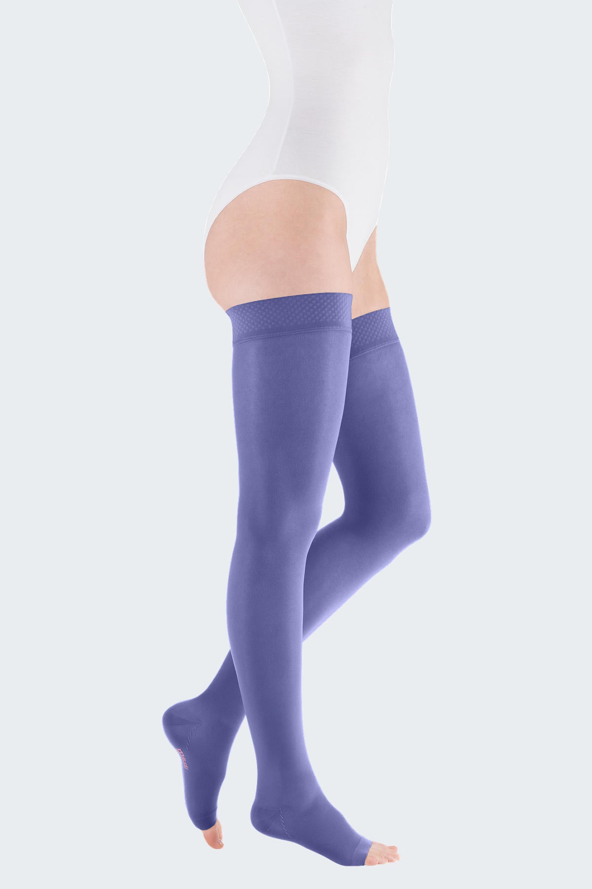 Lower body of female model in thigh-high Mediven Elegance compression tights in lilac.
