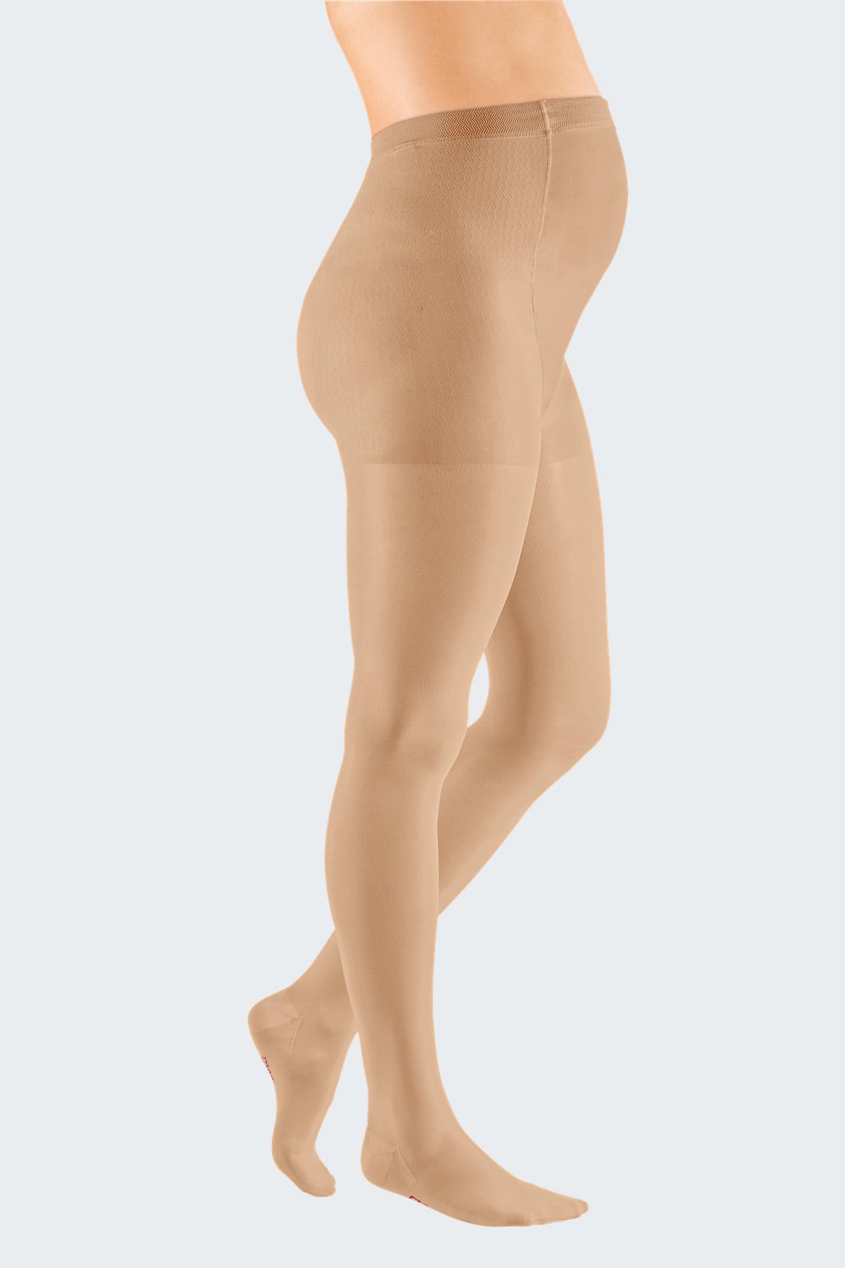 Lower body of female model in Mediven Elegance compression pantyhose in sand.
