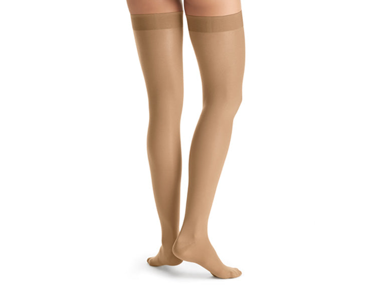 Legs of model in thigh-high JOBST UltraSheer compression tights.