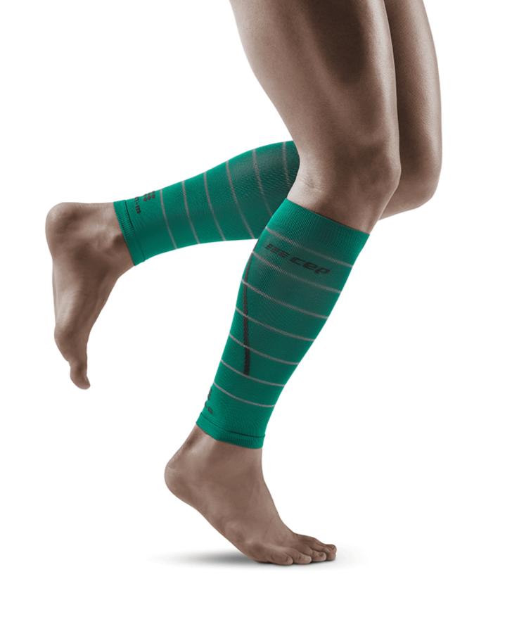 Lower legs of female model in CEP Reflective compression calf sleeves in green.