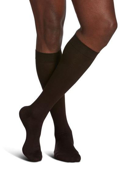 Legs of male model in Sigvaris Sea Island Cotton compression socks in brown.