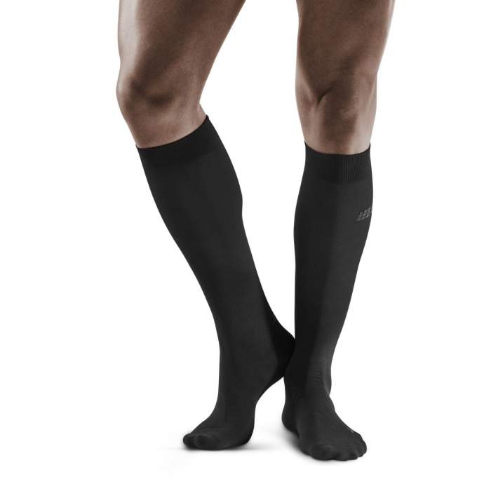 Lower legs of male model wearing knee-high CEP Business compression socks in black.