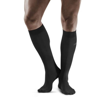 Lower legs of male model wearing knee-high CEP Business compression socks in black.