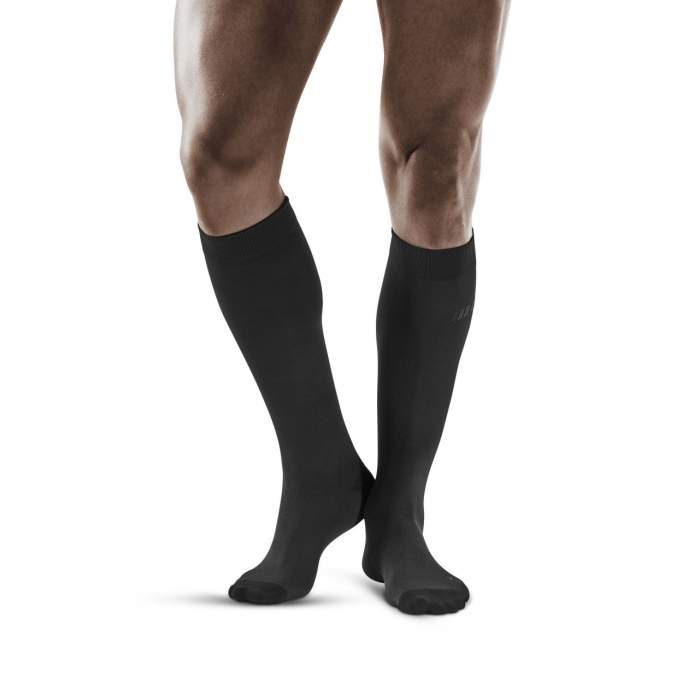 Lower legs of male model wearing knee-high CEP Business compression socks in grey.