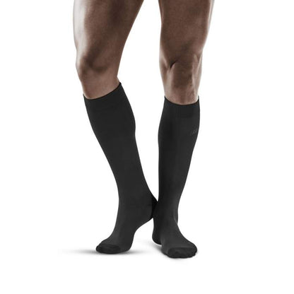 Lower legs of male model wearing knee-high CEP Business compression socks in grey.