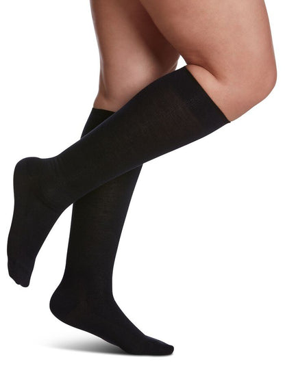Legs of model in Sigvaris Merino Wool compression socks in navy.